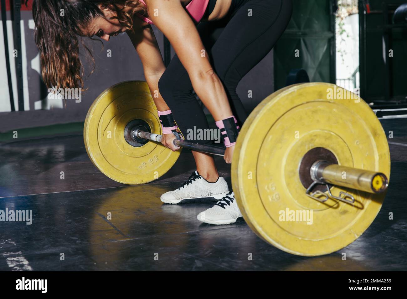 woman with yellow barbell gym. Resolution and high quality beautiful