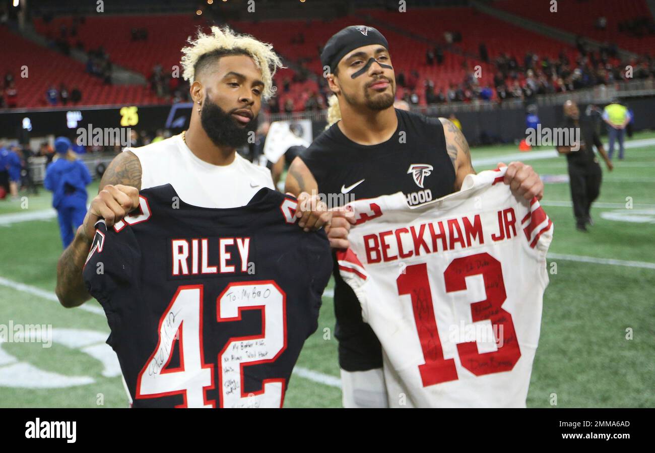 New York Giants wide receiver Odell Beckham, left, holds the jersey of  Atlanta Falcons linebacker Duke Riley after an NFL football game, Monday,  Oct. 22, 2018, in Atlanta. The Atlanta Falcons won
