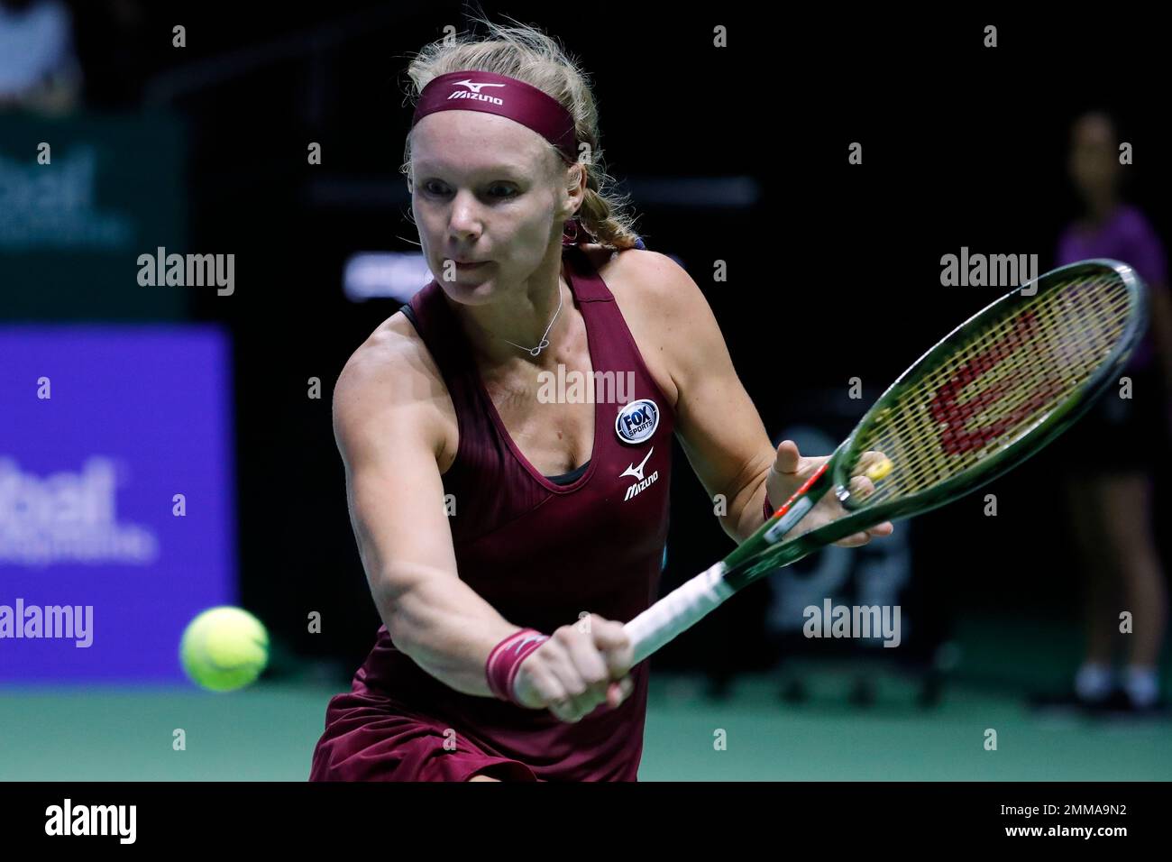 Kiki Bertens of the Netherlands returns a shot to Angelique Kerber of  Germany during their women's singles match at the WTA tennis tournament in  Singapore on Monday, Oct. 22, 2018. (AP Photo/Vincent