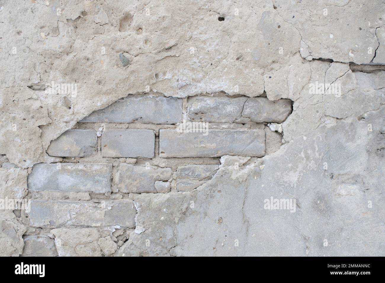 Old brick wall with peeling plaster Stock Photo