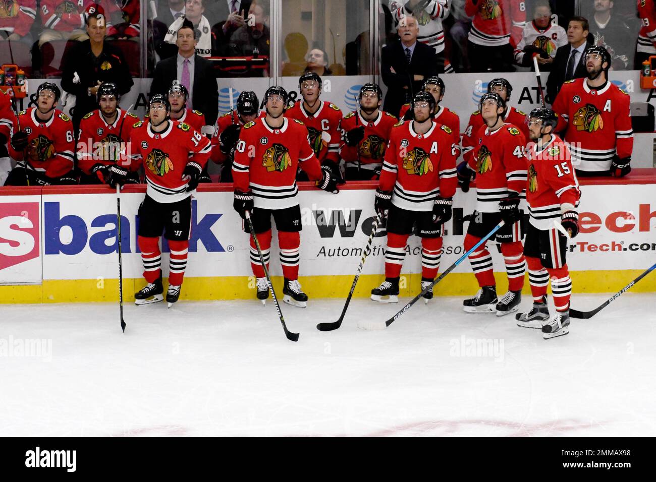 The Chicago Blackhawks watch a video tribute during the first period of an NHL hockey game against the Arizona Coyotes Thursday, Oct