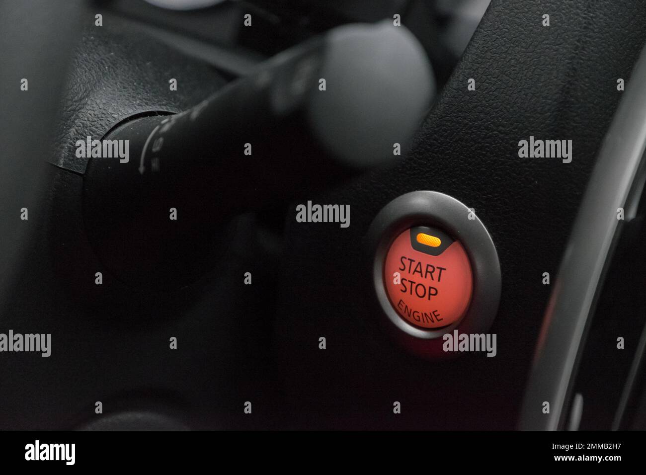 Close up of the red illuminated ignition button of a modern car Stock