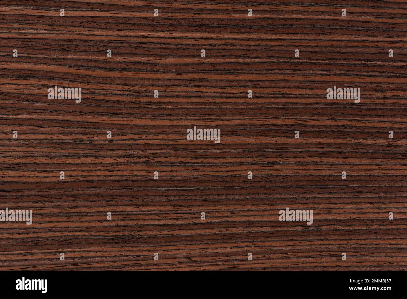 Rosewood texture. Texture of dark mahogany with an intense pattern, natural rosewood veneer for the production of furniture or yacht decoration Stock Photo
