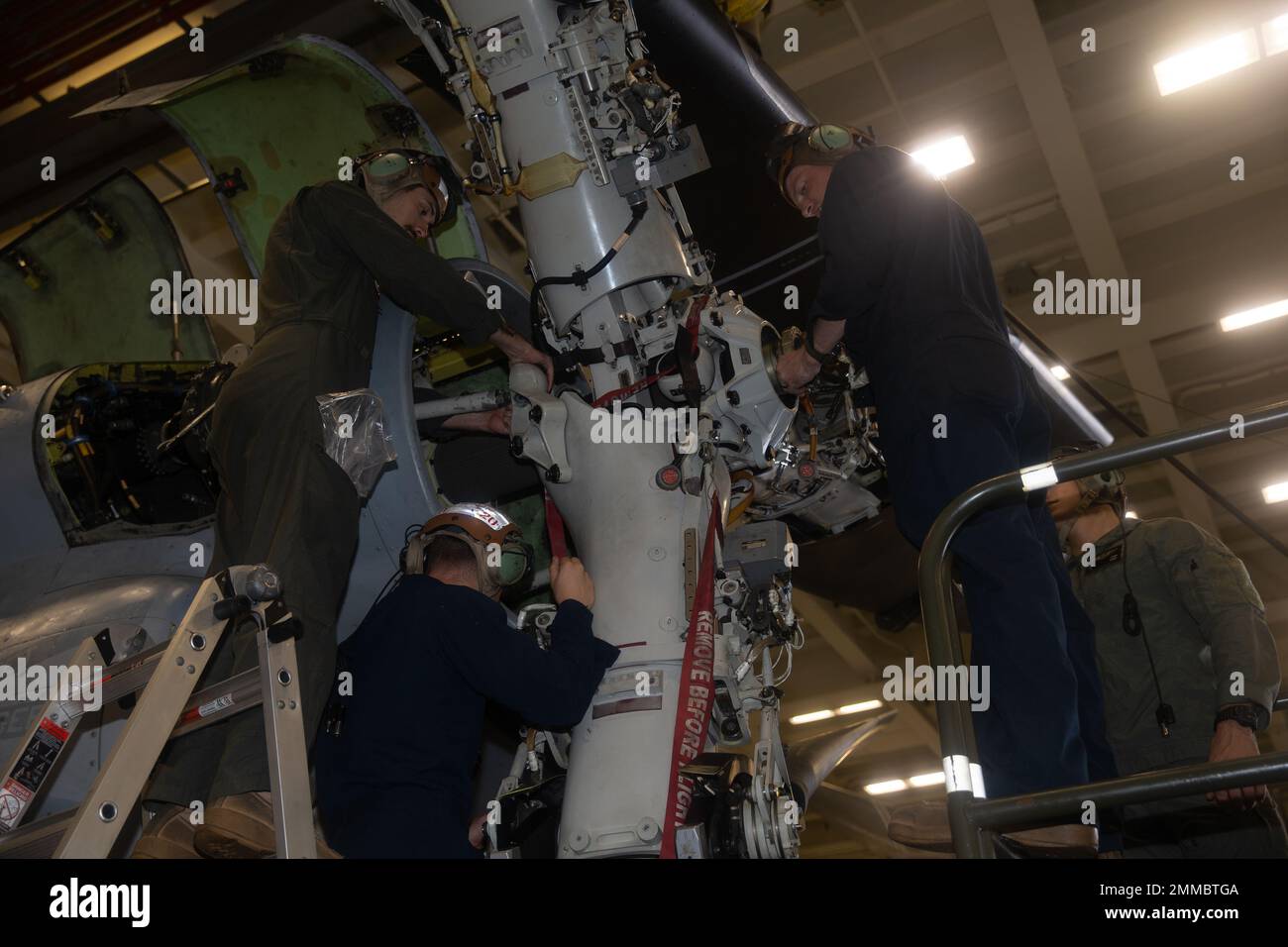 U.S. Marines with Marine Medium Tiltrotor Squadron 262 (Rein.), 31st Marine Expeditionary Unit, secure a propeller onto a MV-22 Osprey in the Philippine Sea, Sept. 16, 2022. The Marines replaced the propeller of the MV-22 Osprey to ensure flight readiness. The 31st MEU is operating aboard ships of the Tripoli Amphibious Ready Group in the 7th Fleet area of operations to enhance interoperability with allies and partners and serve as a ready response force to defend peace and stability in the Indo-Pacific region. Stock Photo