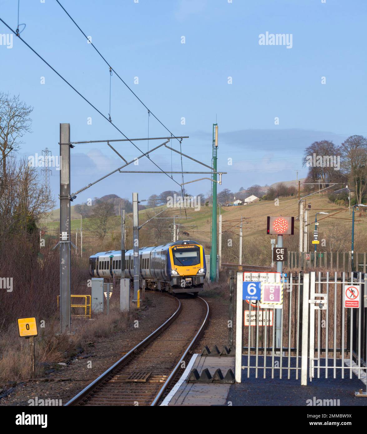 Northern Rail CAF class 195 train 195107 arriving  at Oxenholme the Lake District railway station with a Windermere branch train Stock Photo