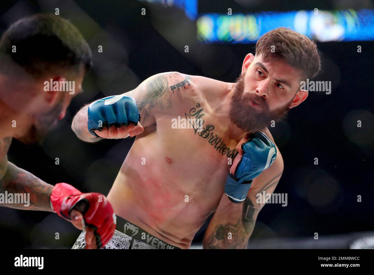 Andy Main pursues Henry Corrales during a mixed martial arts bout at