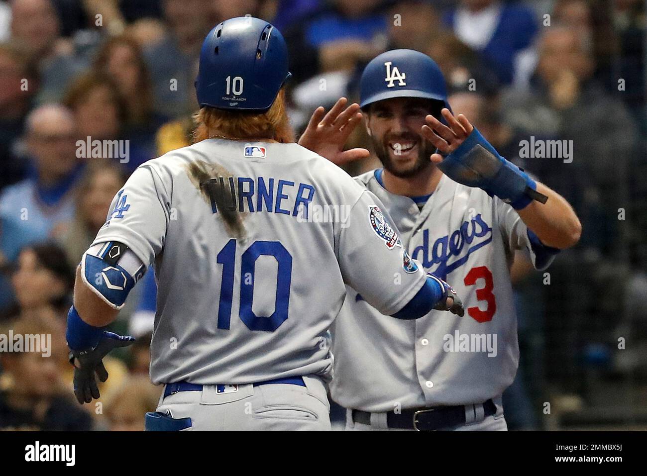 Los Angeles Dodgers' Justin Turner (10) celebrates with Chris Taylor (3)  after hitting a two-run home run during the eighth inning of Game 2 of the  National League Championship Series baseball game
