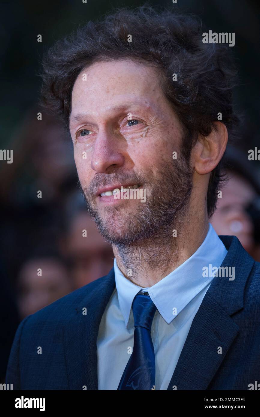 Actor Tim Blake Nelson poses for photographers upon arrival at the