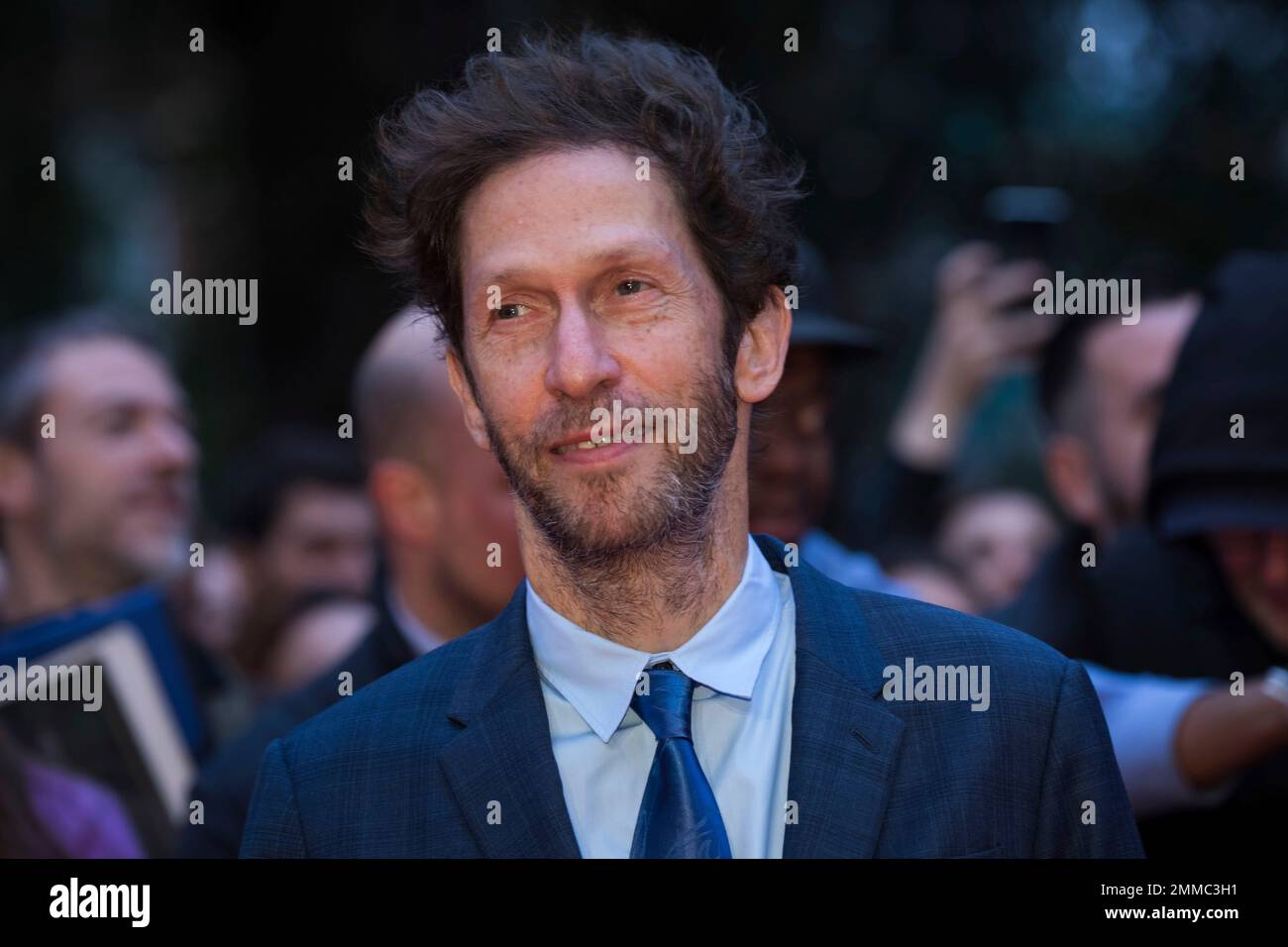 Actor Tim Blake Nelson poses for photographers upon arrival at the