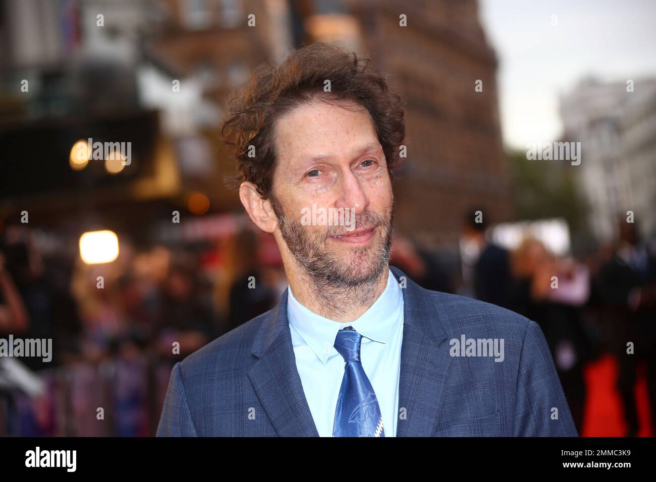 Actor Tim Blake Nelson poses for photographers upon arrival at the