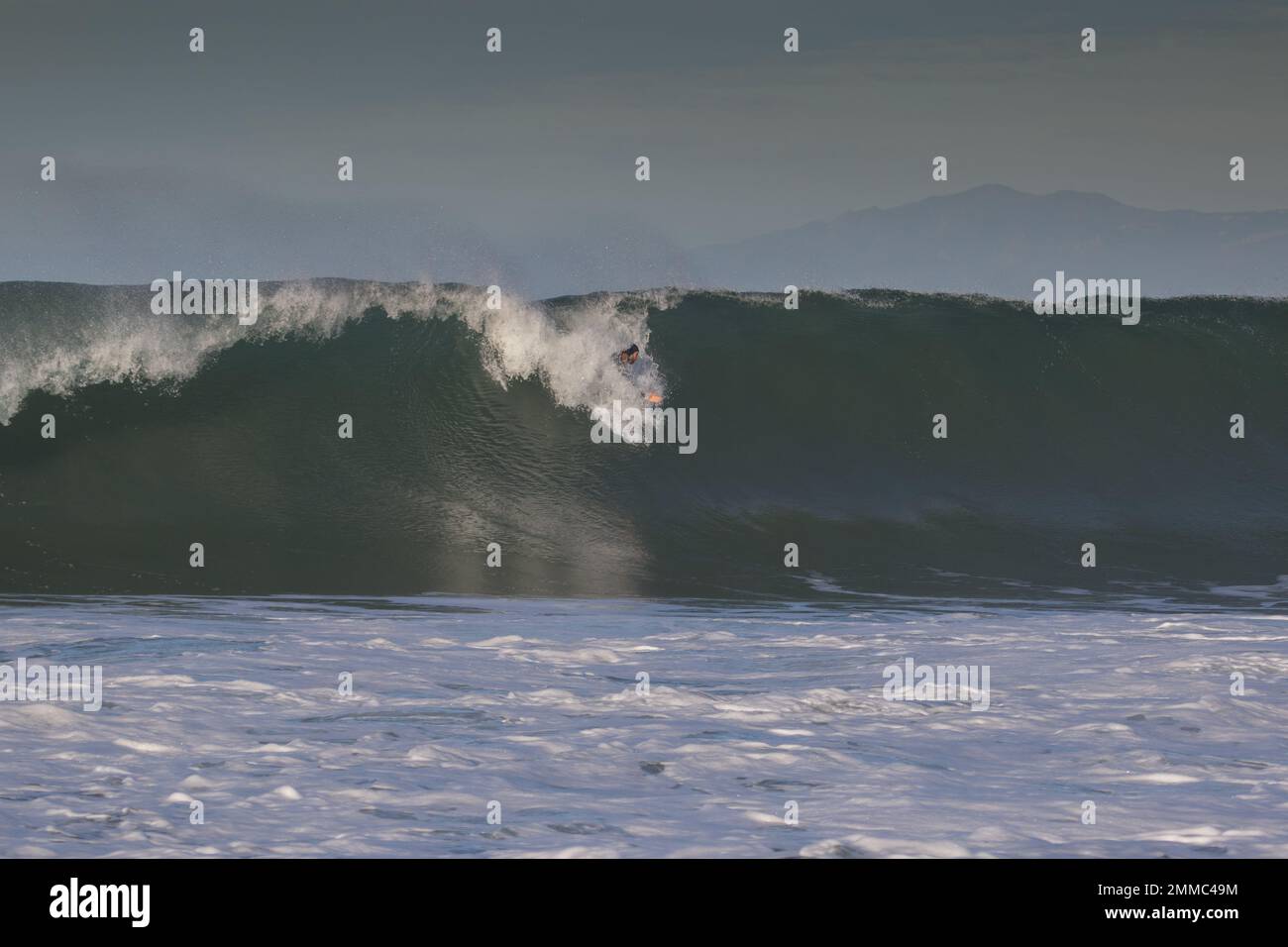 Bodysurfing waves at the South Jetty body surfing competition 2022 in Ventura, California , USA Stock Photo