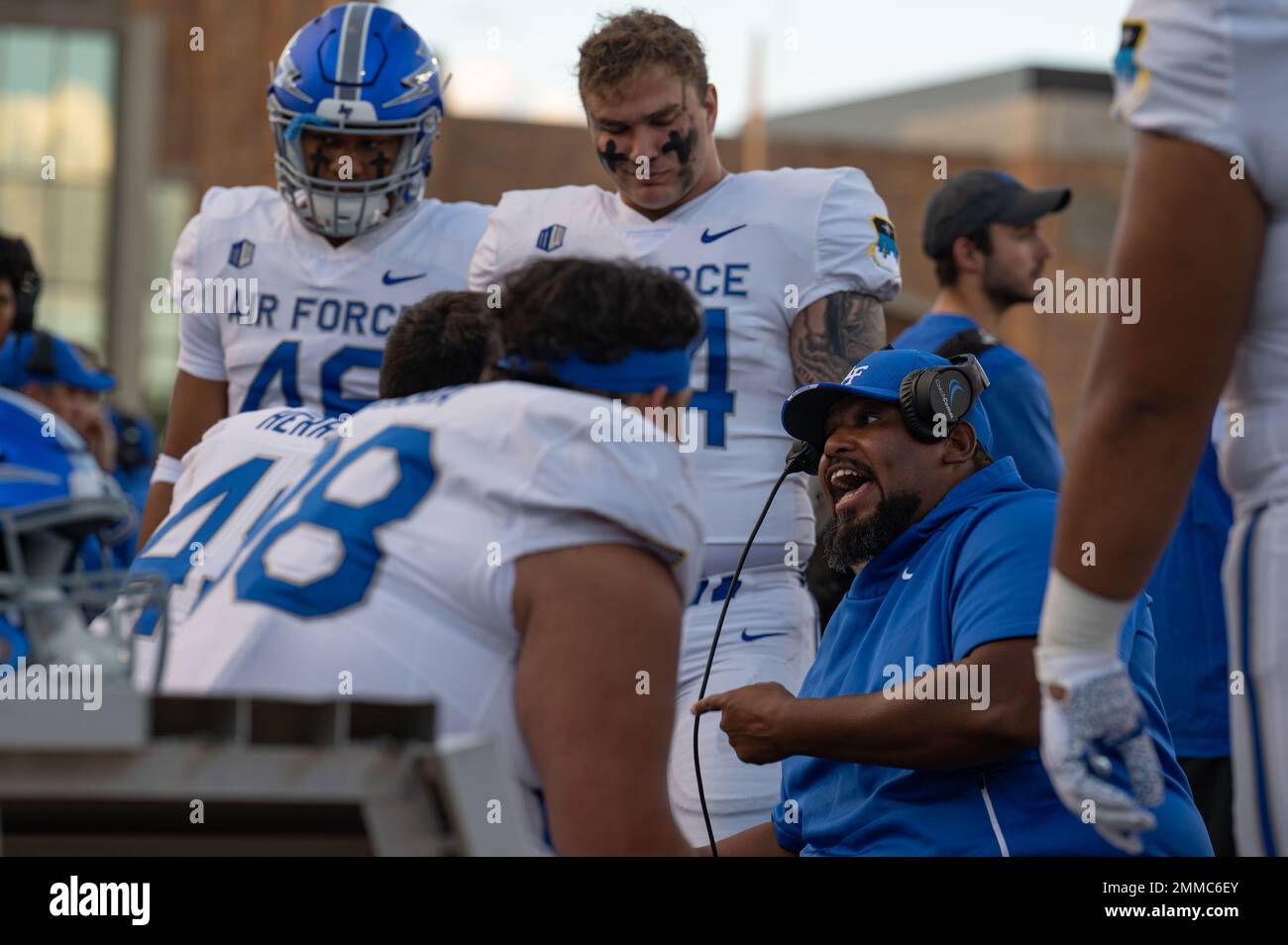 A coach talks to his team, Sept. 16, 2022, at War Memorial Stadium in Laramie, Wyoming. The Air Force Academy traveled from Colorado Springs to Laramie, to play the Wyoming Cowboys in football. Stock Photo