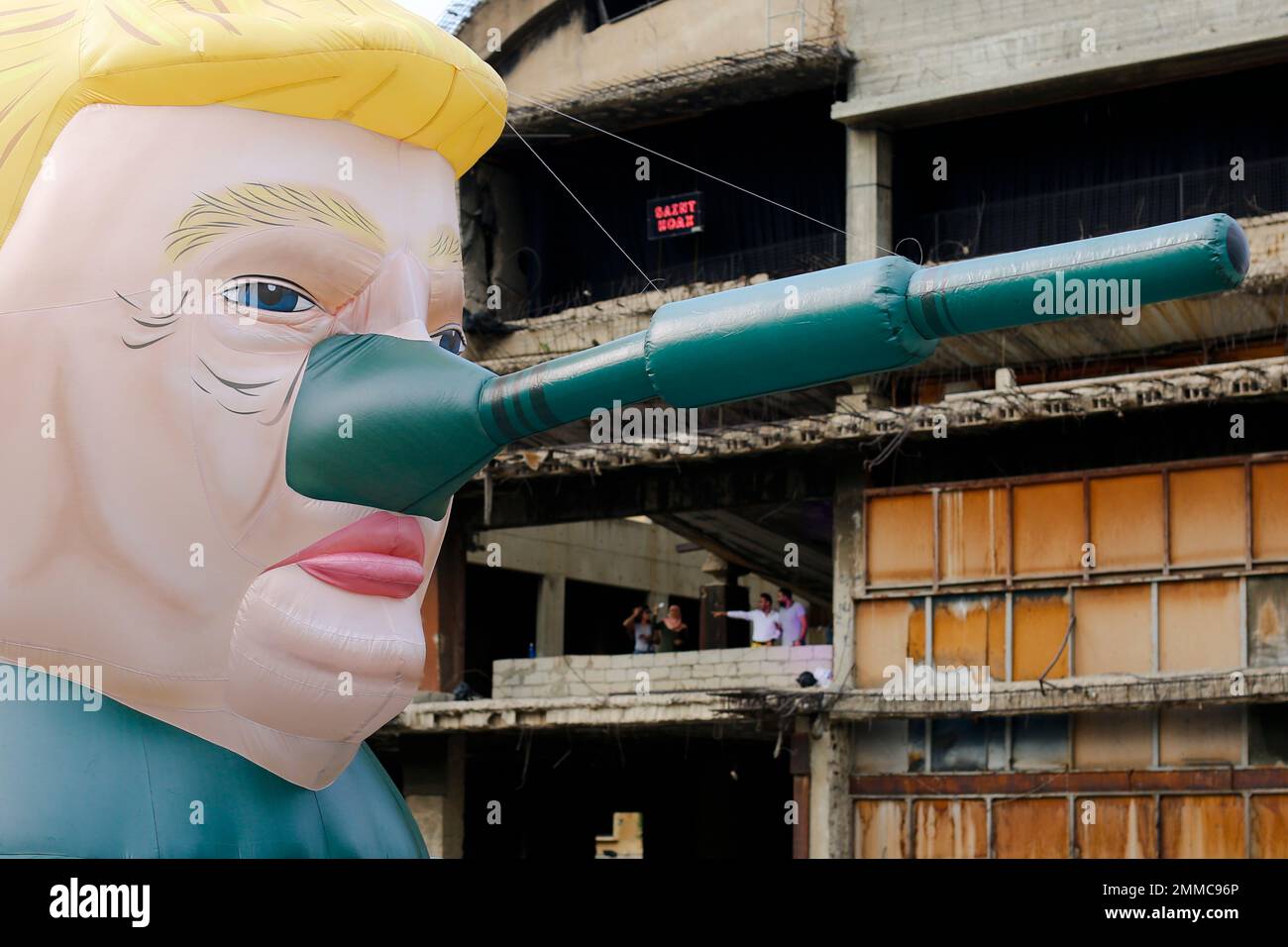 Visitors photograph a giant inflatable tank with U.S. President Donald ...