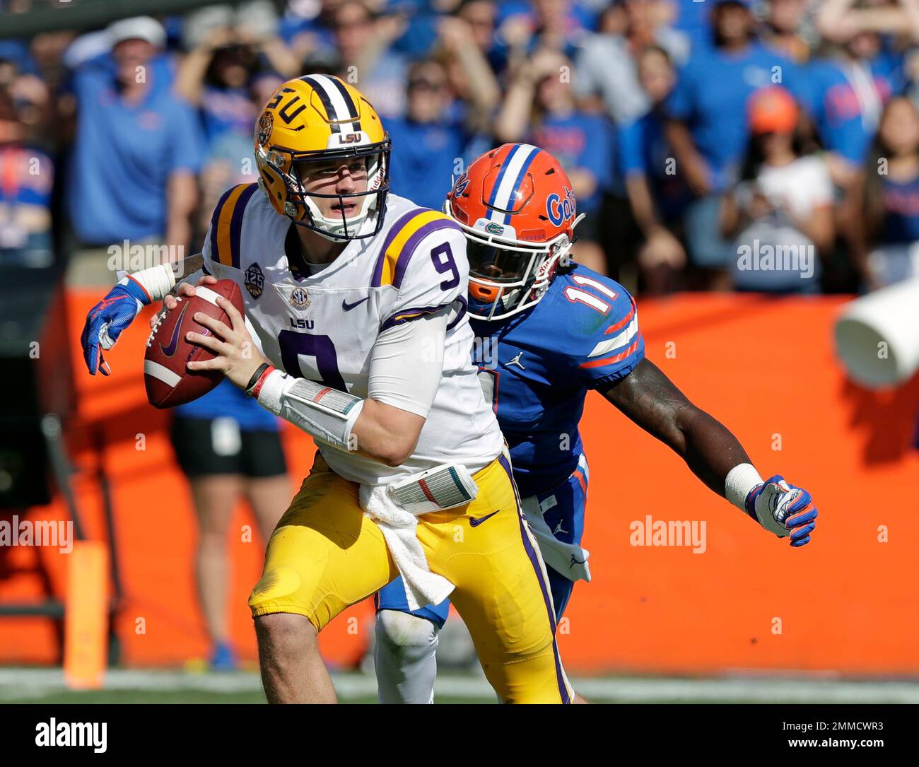 LSU quarterback Joe Burrow, left, is sacked by Florida linebacker
