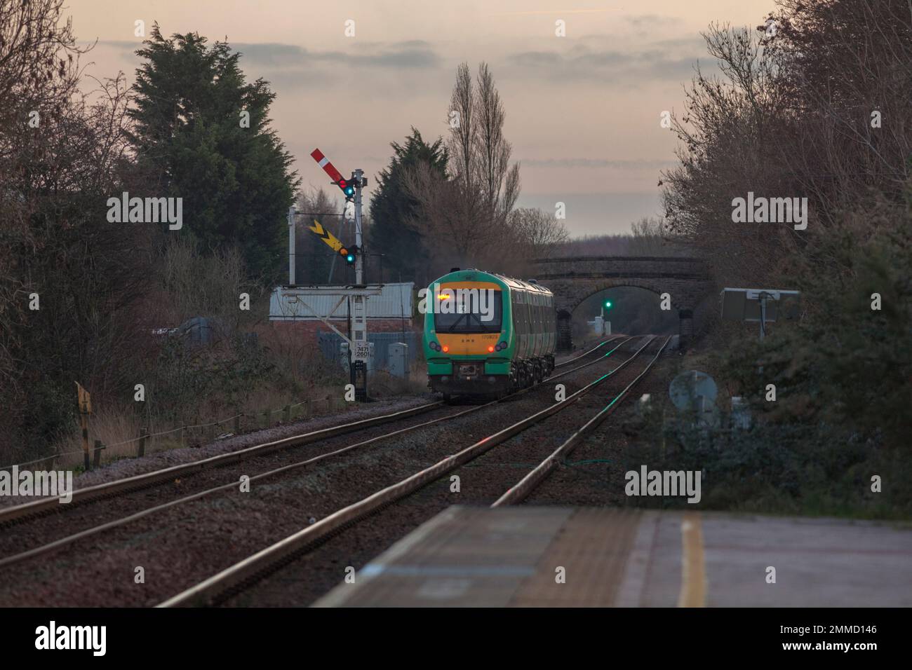 East Midlands railway class 170 Turbostar 170923 (still carrying Southern livery) departing Creswell on the Robin Hood line passing a semaphore signal Stock Photo