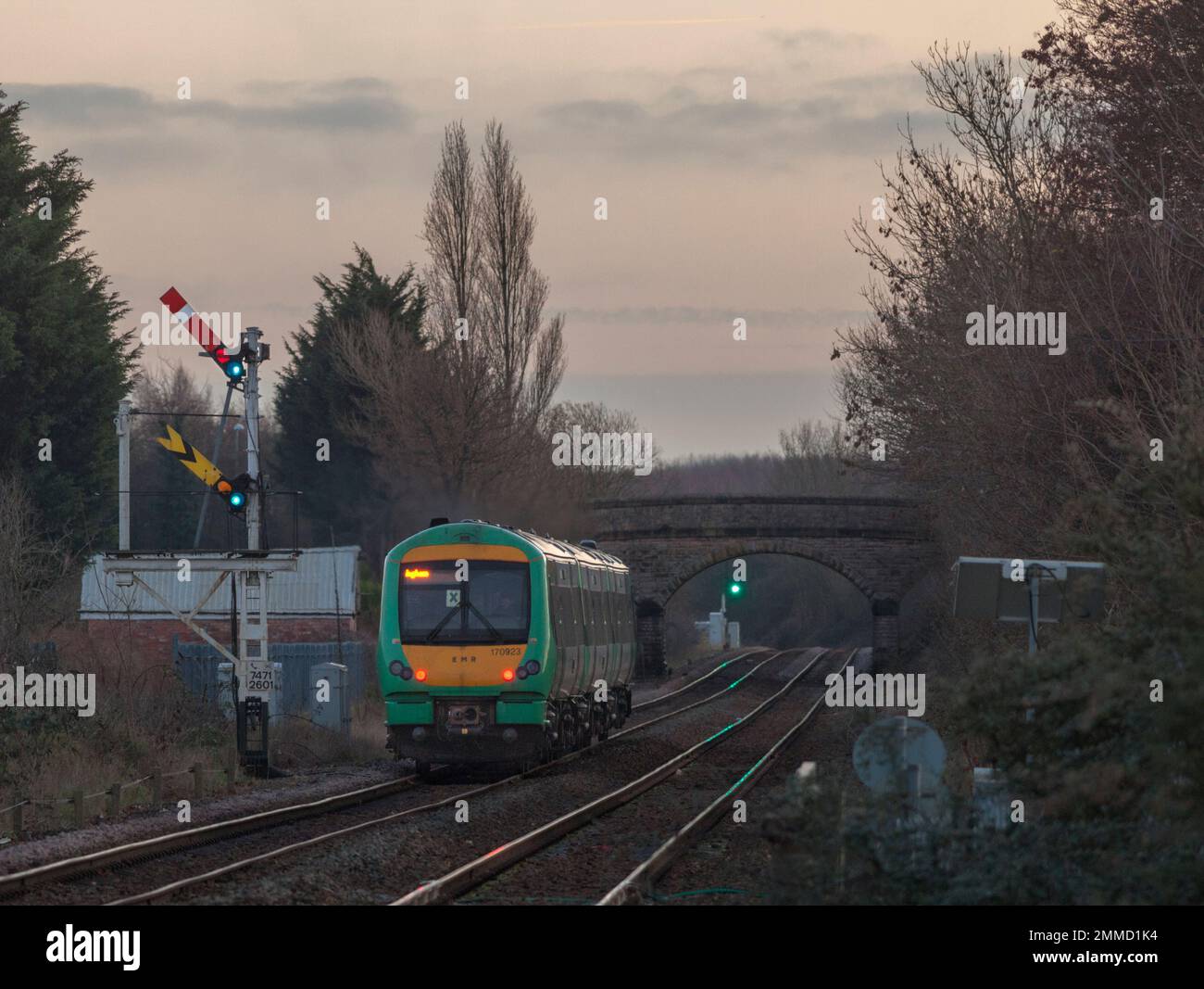 East Midlands railway class 170 Turbostar 170923 (still carrying Southern livery) departing Creswell on the Robin Hood line passing a semaphore signal Stock Photo