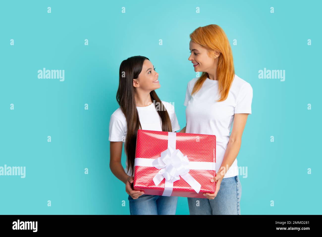 Love mom. Smiling mother and daughter with gift box. Mothers day. Cheerful mom and her cute daughter girl with gifts. Stock Photo