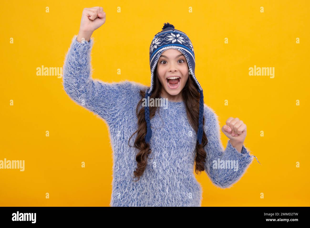 Modern teenage girl 12, 13, 14 year old wearing sweater and knitted hat