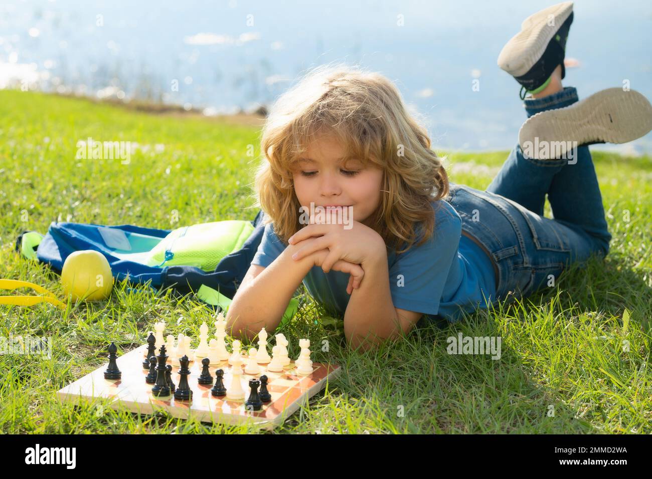 Chess game for children. Kid playing chess. Games and activities for children. Stock Photo