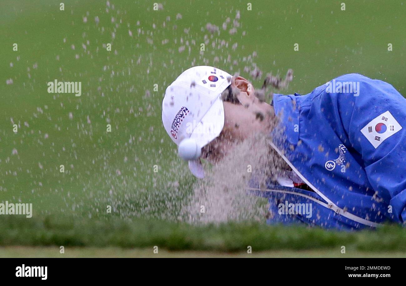 Sung Hyun Park of South Korea hits out of a bunker on the first hole during the second round of