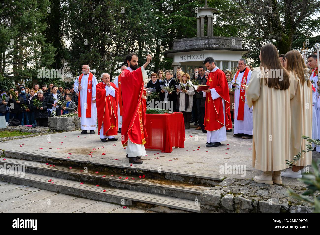 Blessing of the palms on Palm Sunday in Medjugorje, Bosnia and Herzegovina. Msgr. Aldo Cavalli, the Apostolic Visitor to Medjugorje, is also present. Stock Photo