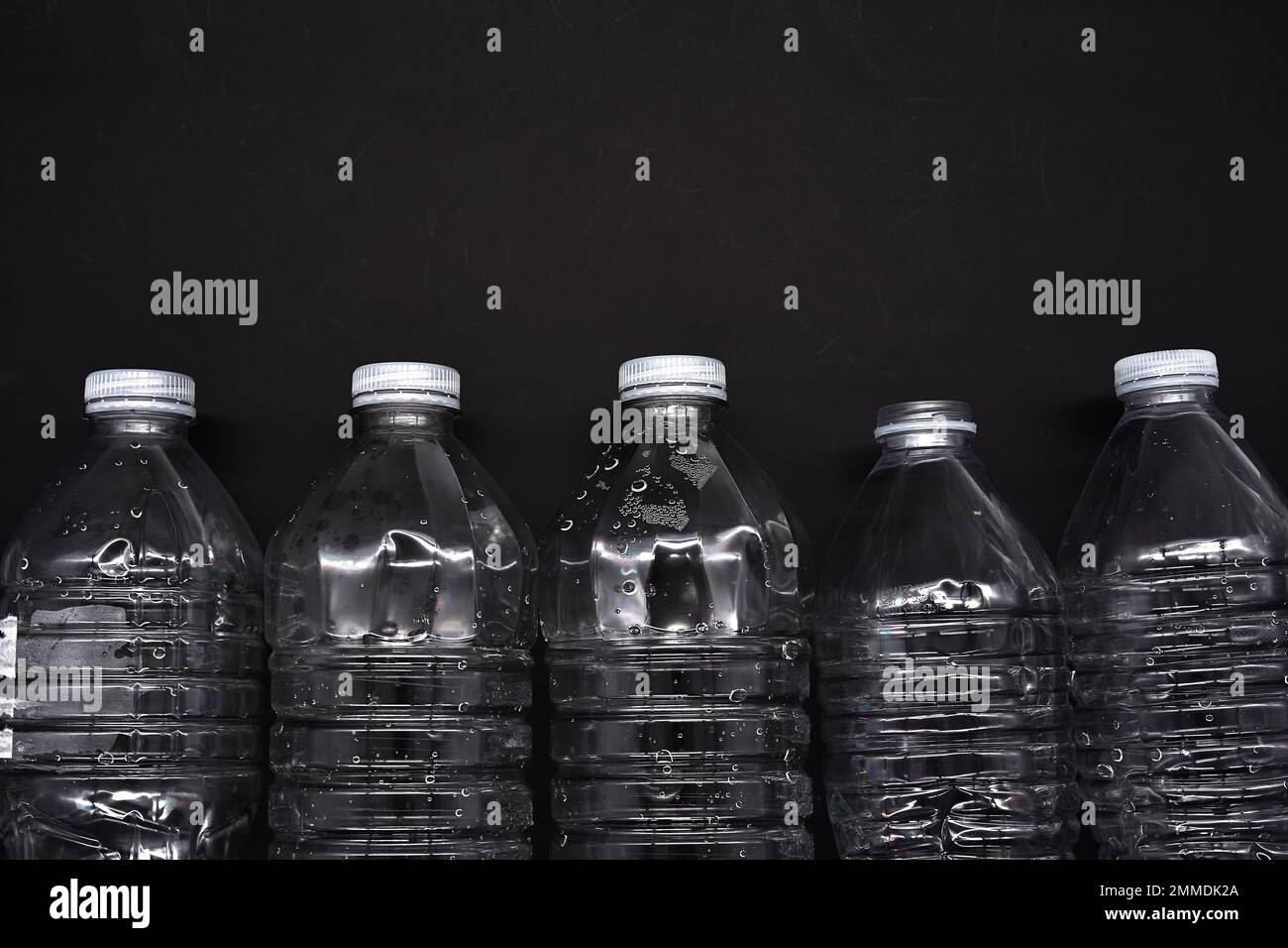 Empty plastic water bottles recycle material reduce waste back background Stock Photo