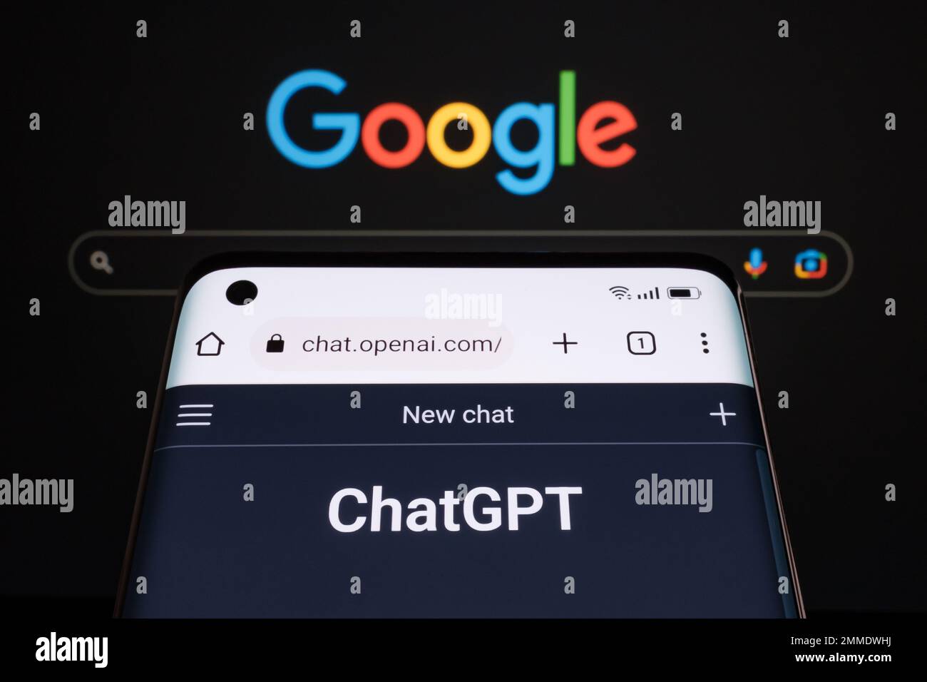 ChatGPT chat bot page seen on smartphone and laptop display with blurred GOOGLE search page. AI chatbot vs search engine. Concept. Stafford, United Ki Stock Photo