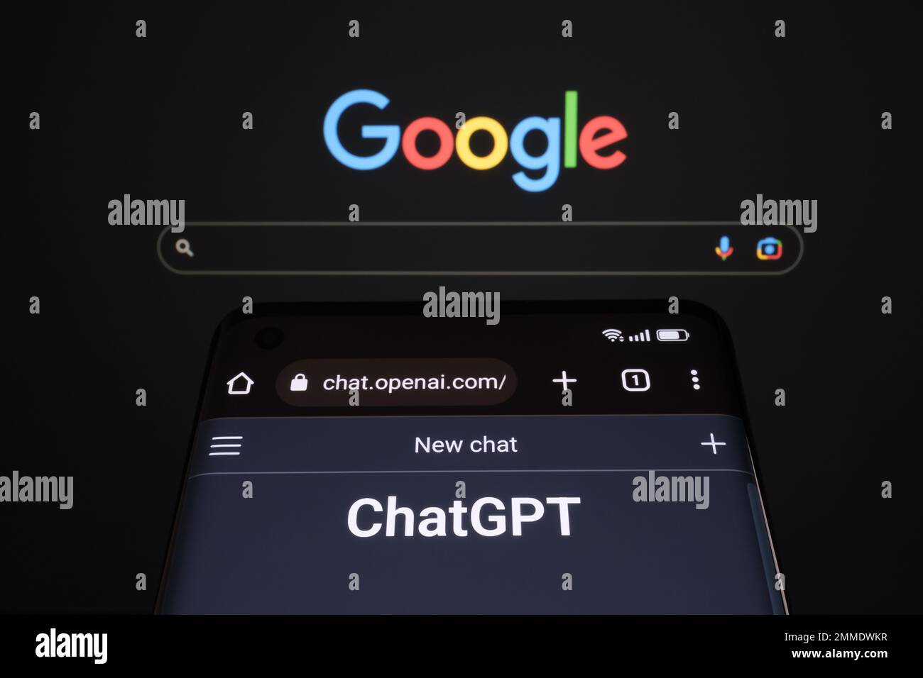 ChatGPT chat bot page seen on smartphone and laptop display with blurred GOOGLE search page. AI chatbot vs search engine. Concept. Stafford, United Ki Stock Photo