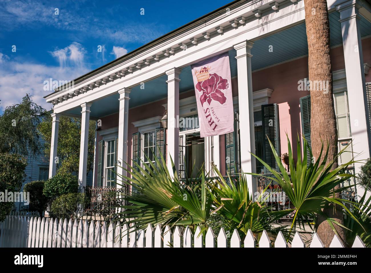 NEW ORLEANS, LA, USA - JANUARY 27, 2023: Front  of Historic Italianate raised center-hall home on Maple Street displaying a Krewe of Iris Flag Stock Photo