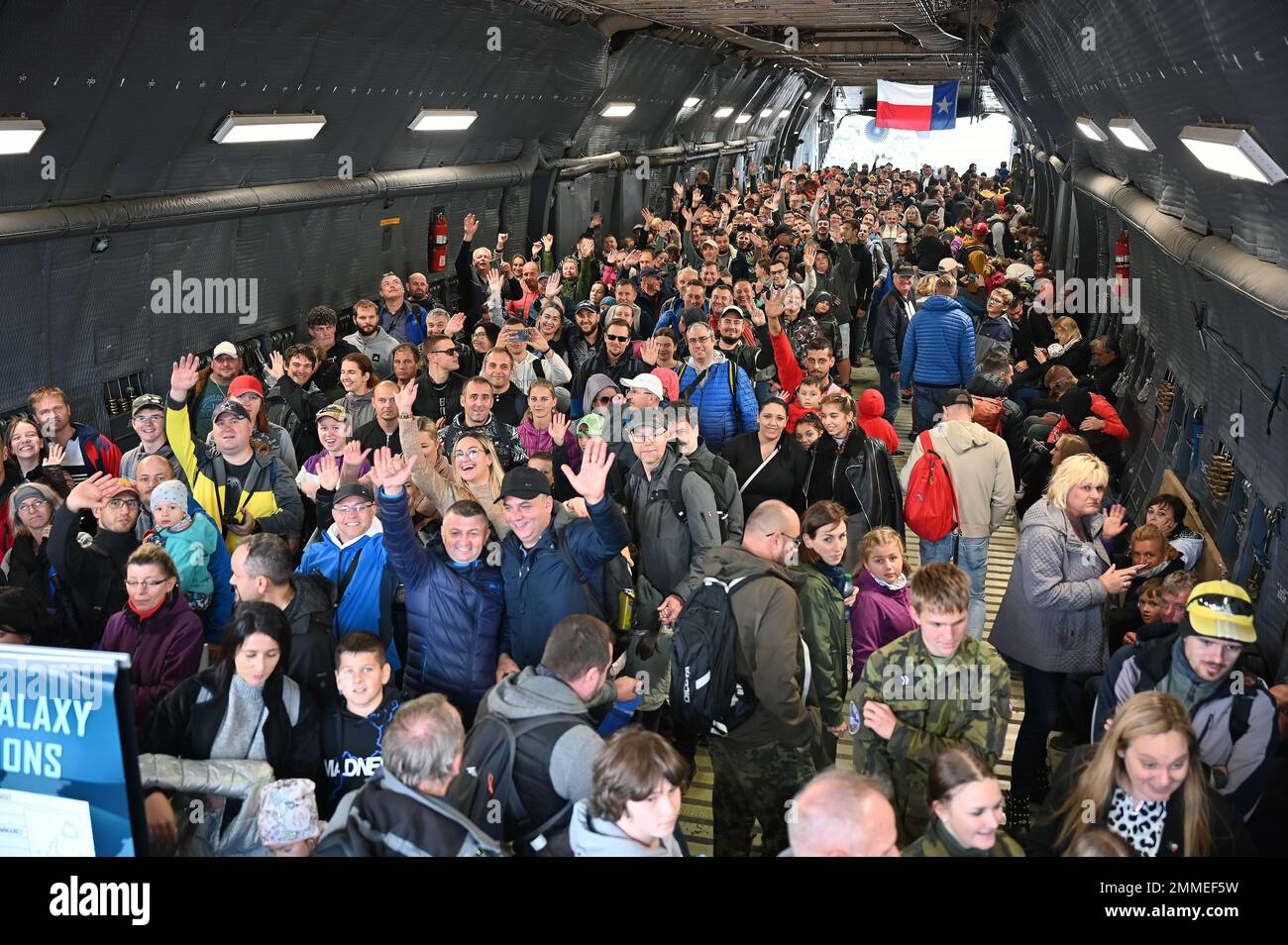 NATO Days air show participants smile and wave as they walk through a C-5M Super Galaxy aircraft in Ostrava, Czech Republic Sept. 17, 2022. The C-5M was the largest aircraft on display during the two-day event. Stock Photo