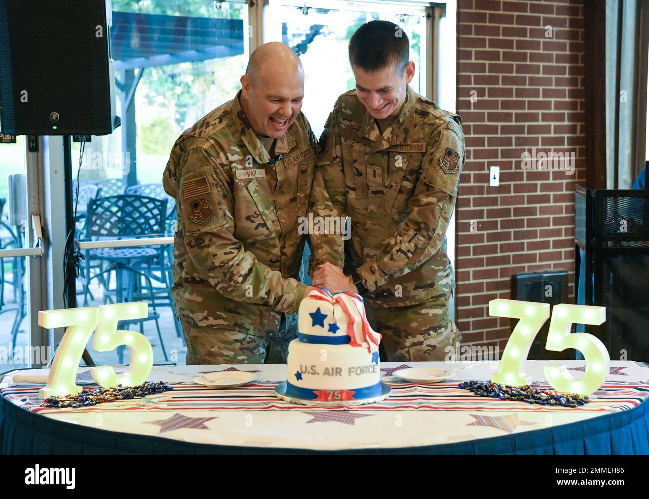 Col. Jason Vap, commander, 804th Test Group, Arnold Engineering Development  Complex, and 2nd Lt. Ben West, 718th Test Squadron, 804th Test Group, use a  sword to cut a cake in honor of