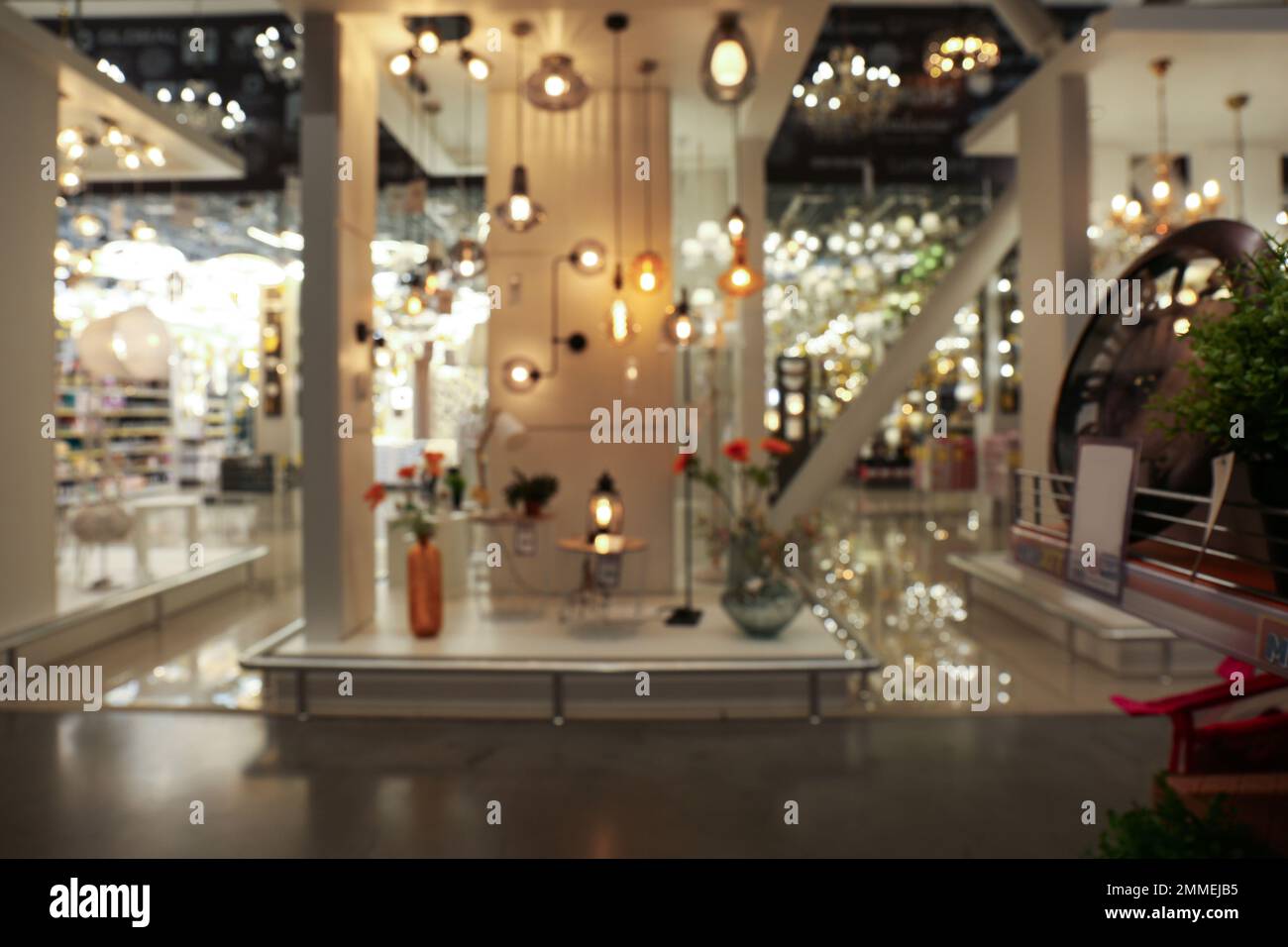 Blurred view of lighting store in shopping mall. Bokeh effect Stock Photo