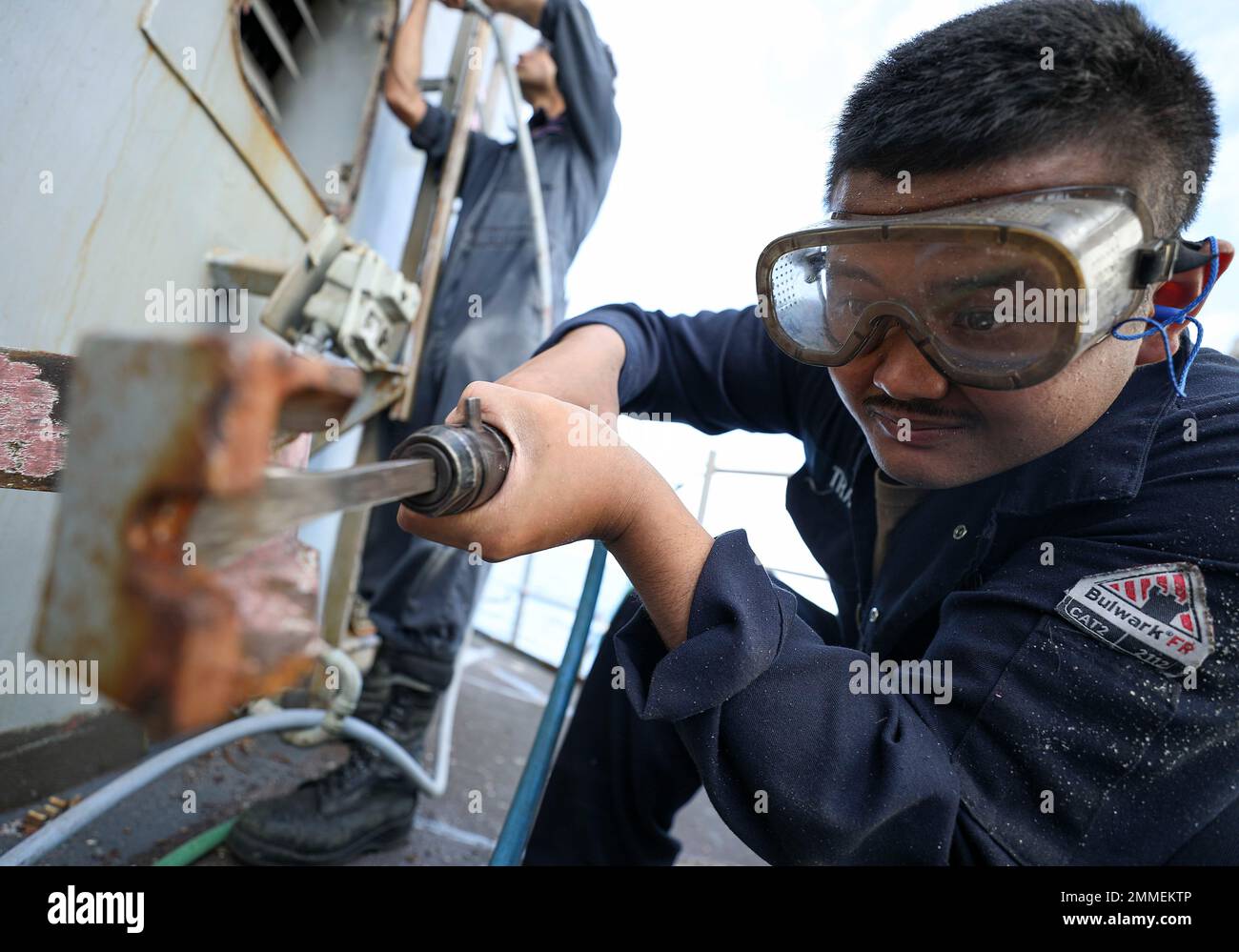 PHILIPPINE SEA (Sept. 16, 2022) – Fireman Kenny Tran, from Jacksonville, Florida, conducts maintenance aboard Arleigh Burke-class guided-missile destroyer USS Barry (DDG 52) while operating in the Philippine Sea, Sept. 16. Barry is assigned to Commander, Task Force 71/Destroyer Squadron (DESRON) 15, the Navy’s largest forward-deployed DESRON and the U.S. 7th Fleet’s principal surface force. Stock Photo