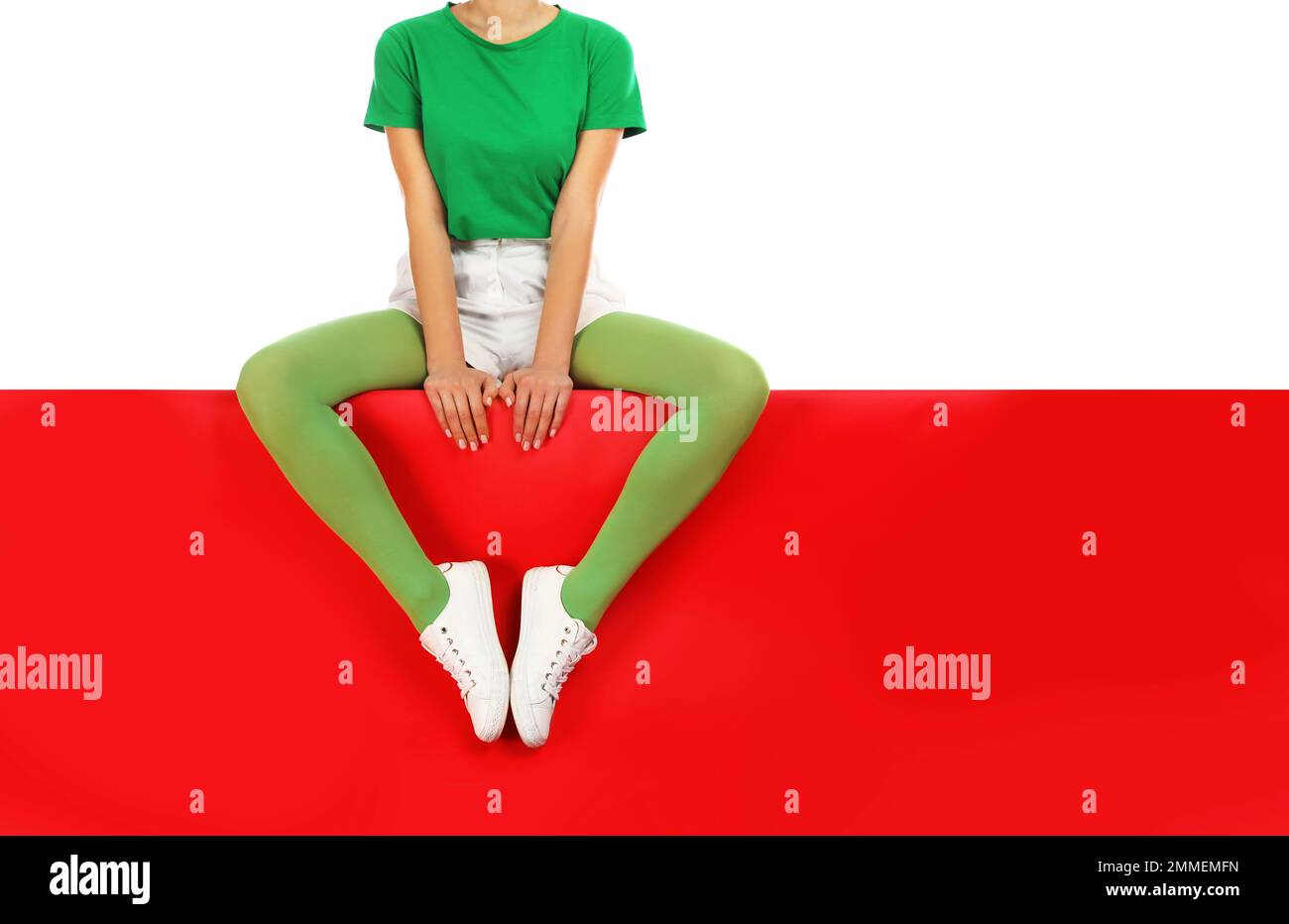 https://c8.alamy.com/comp/2MMEMFN/woman-wearing-green-tights-sitting-on-color-background-closeup-space-for-text-2MMEMFN.jpg