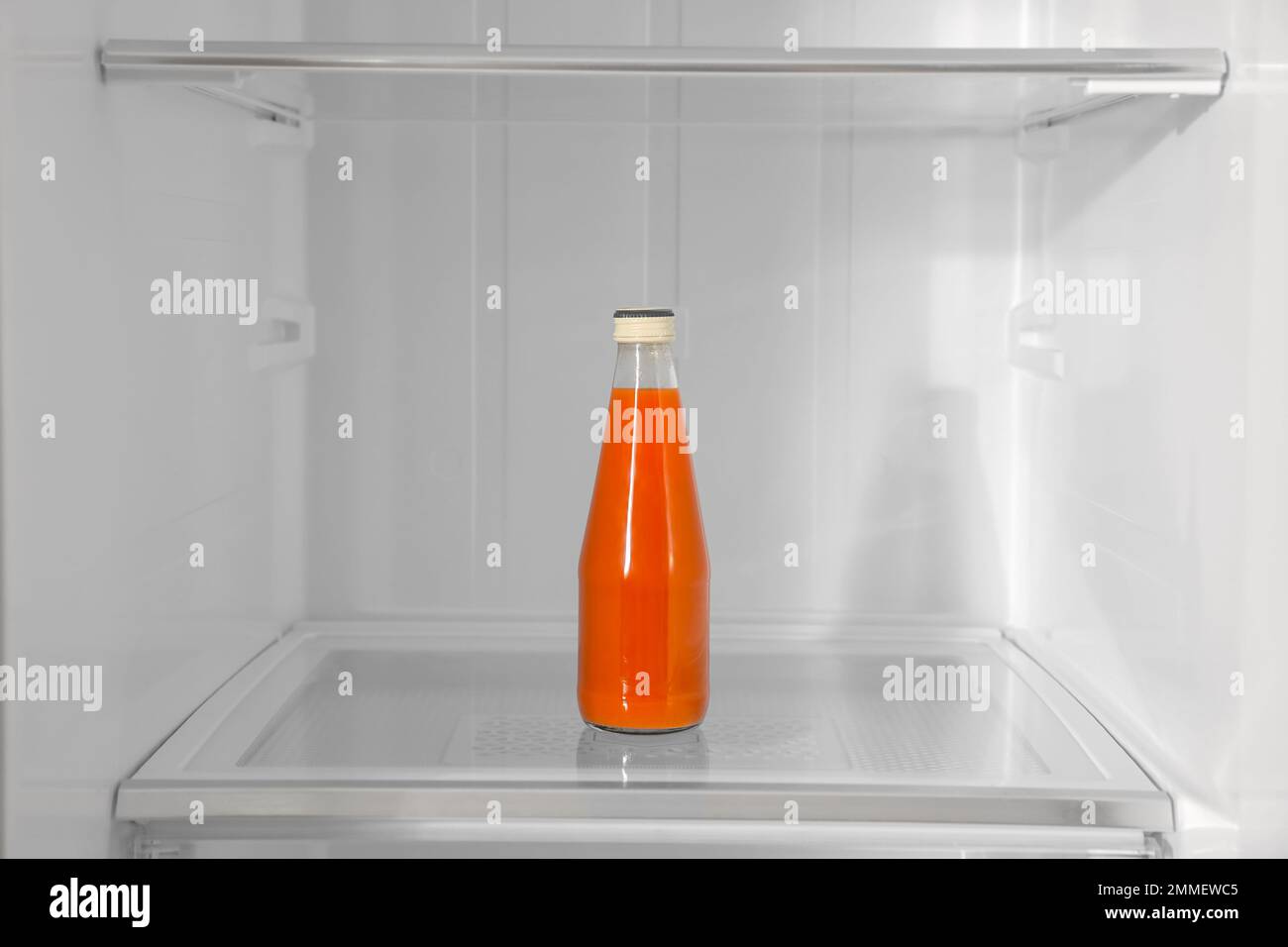 Bottle of juice on shelf inside modern refrigerator Stock Photo Alamy
