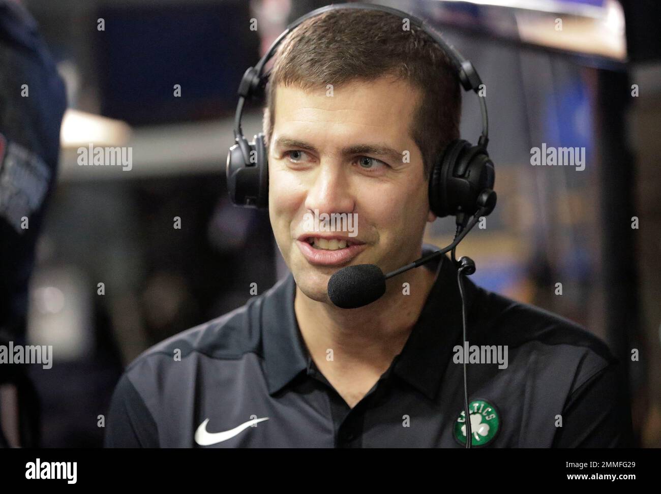 Boston Celtics head coach Brad Stevens wears earphones during an
