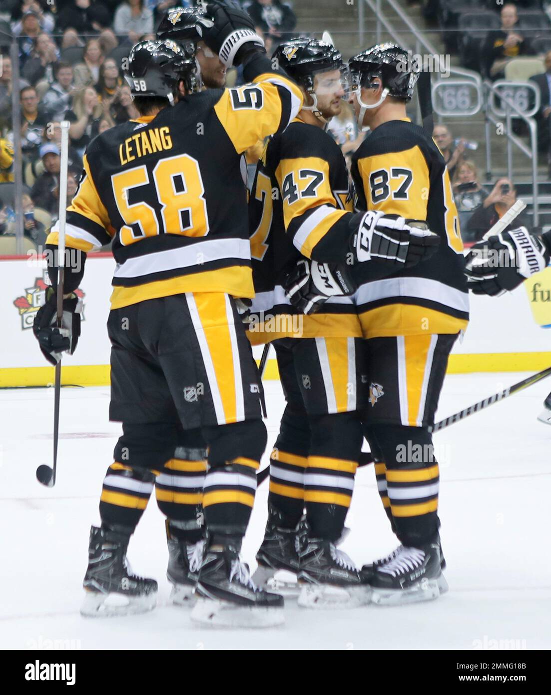 Pittsburgh Penguins' Adam Johnson (47) celebrates with Sidney Crosby