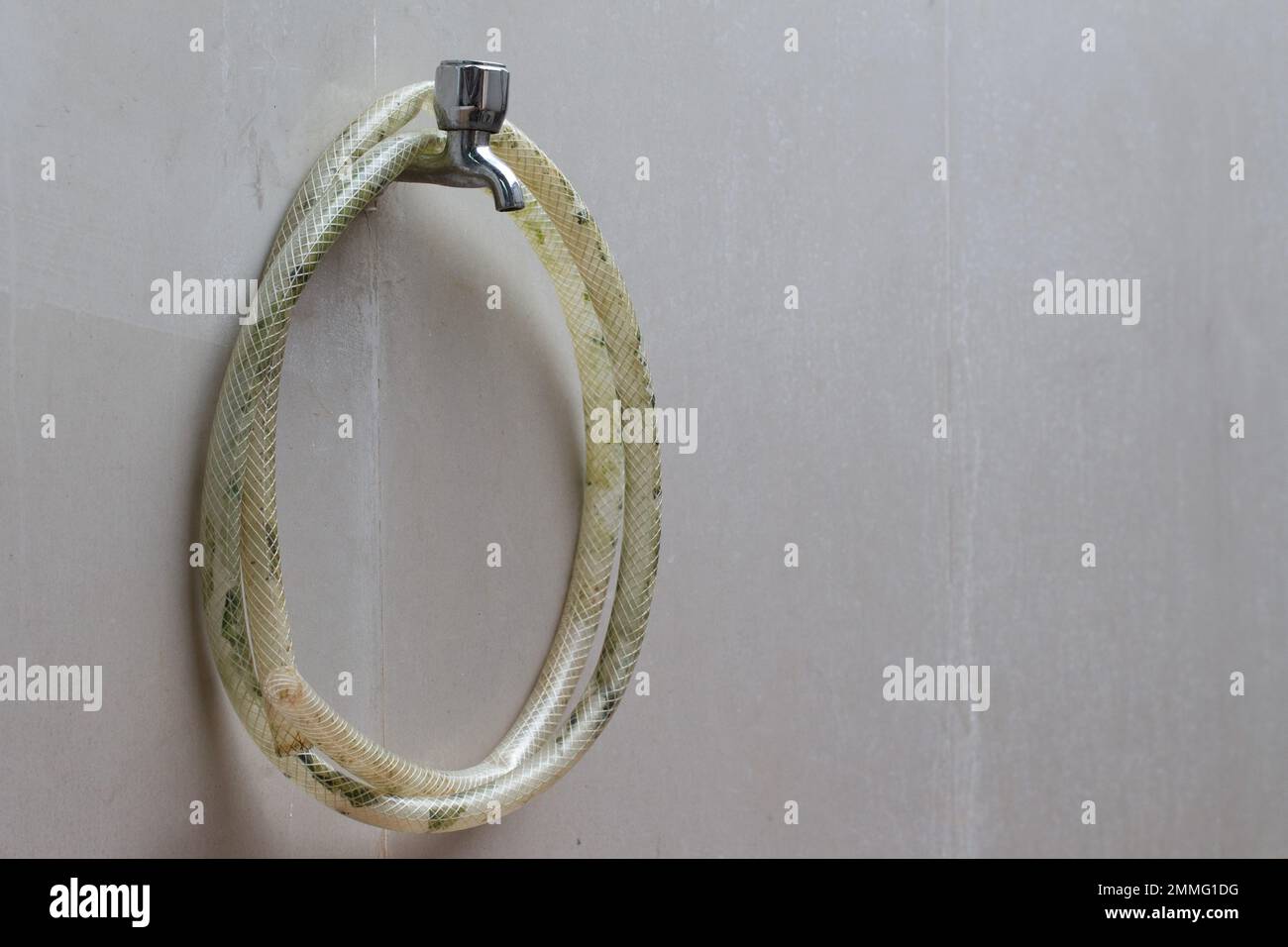 the water hose is hanging on the bathroom wall faucet Stock Photo Alamy