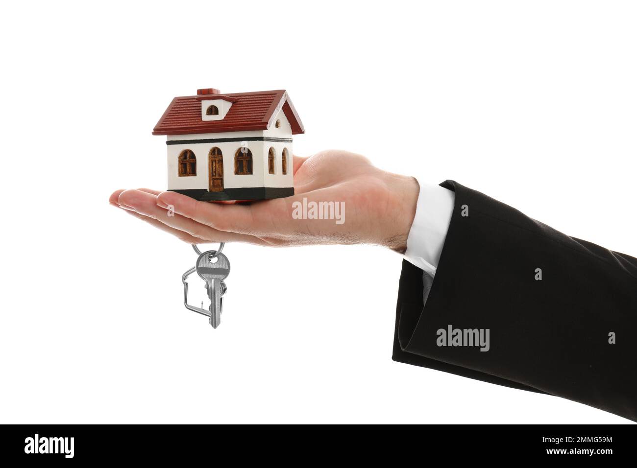 Real estate agent holding house model and key on white background ...