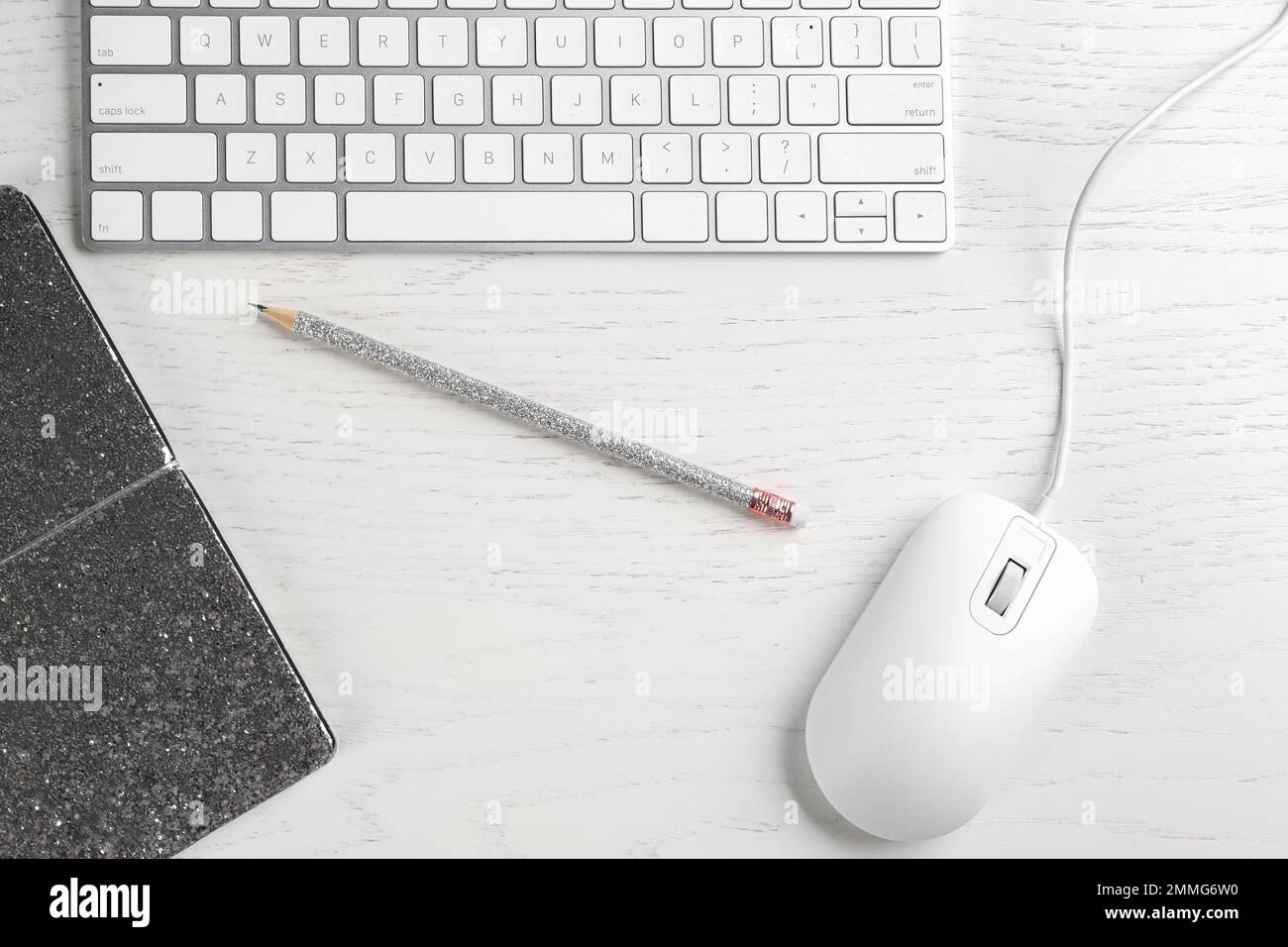 Flat lay composition with mouse and keyboard on white wooden table Stock Photo