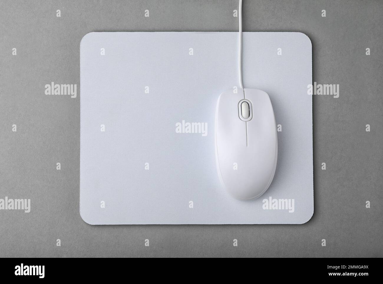 Wired computer mouse and pad on grey background, flat lay Stock Photo