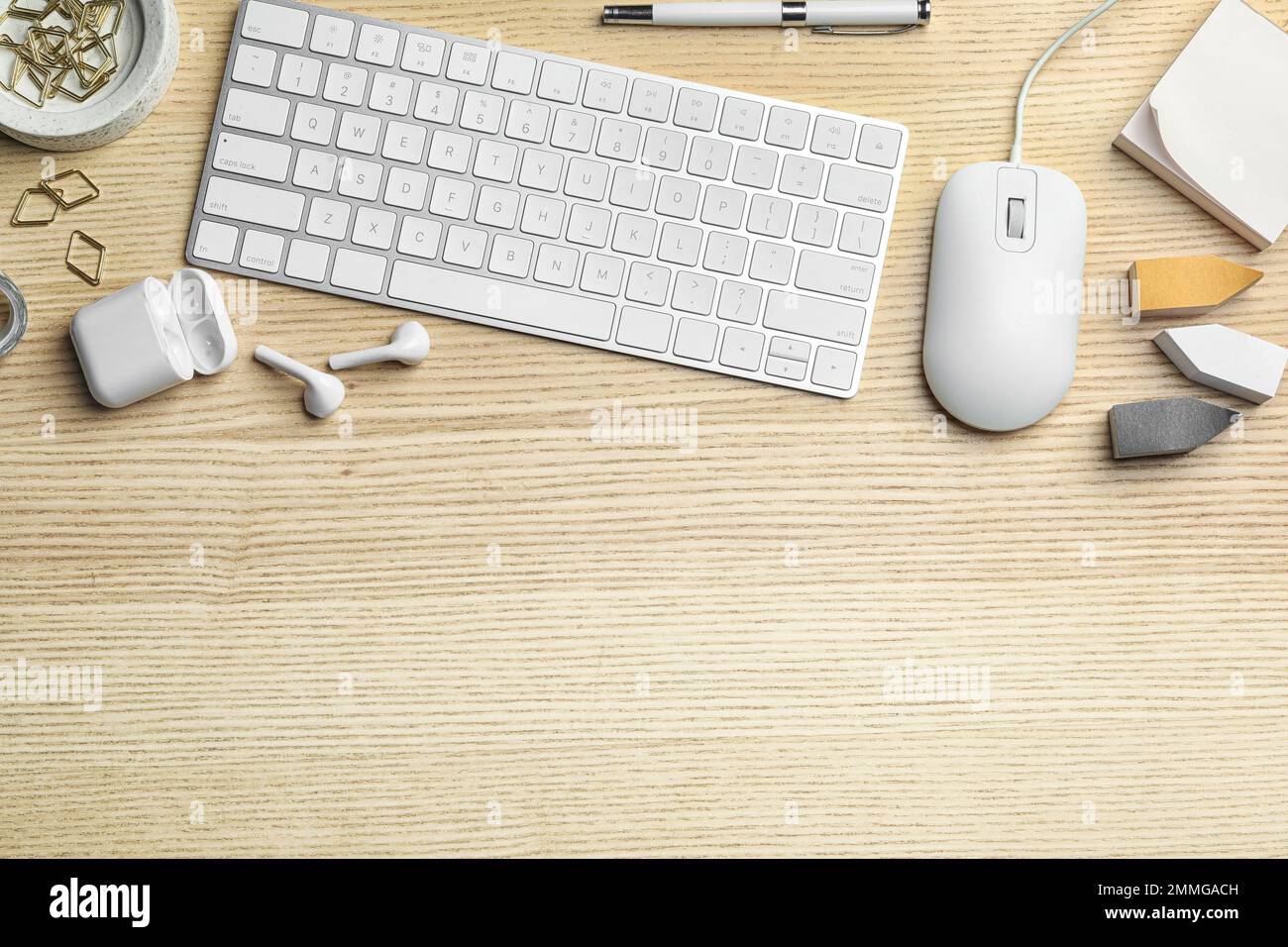 Flat lay composition with wired computer mouse and keyboard on  wooden table. Space for text Stock Photo