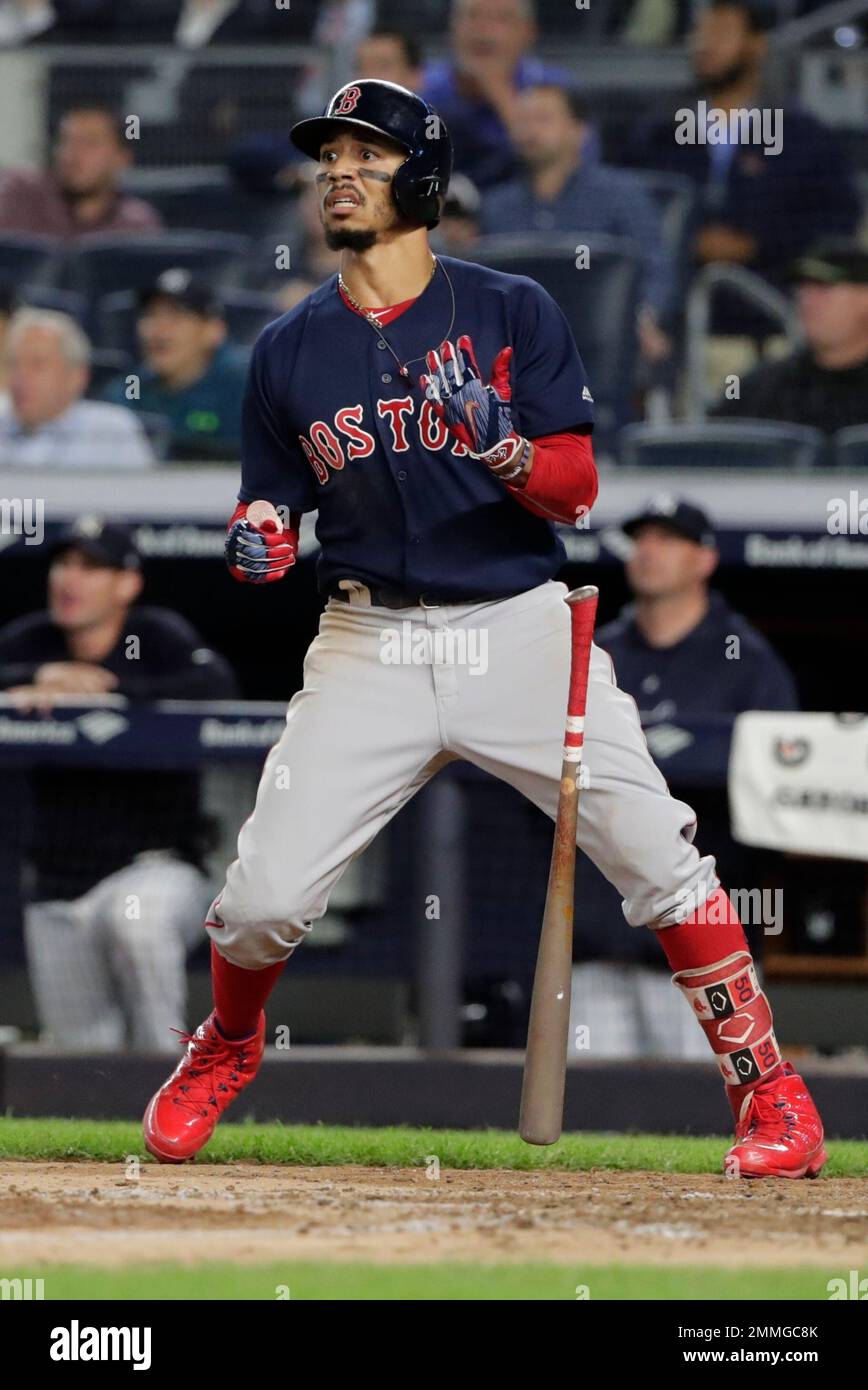 Boston Red Sox's Mookie Betts flips his bat after hitting a