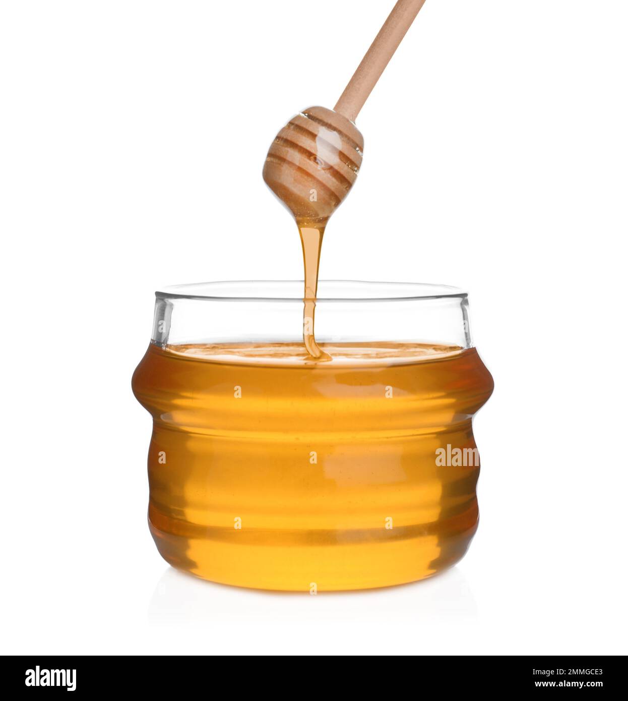 Honey dripping from wooden dipper into jar isolated on white Stock ...