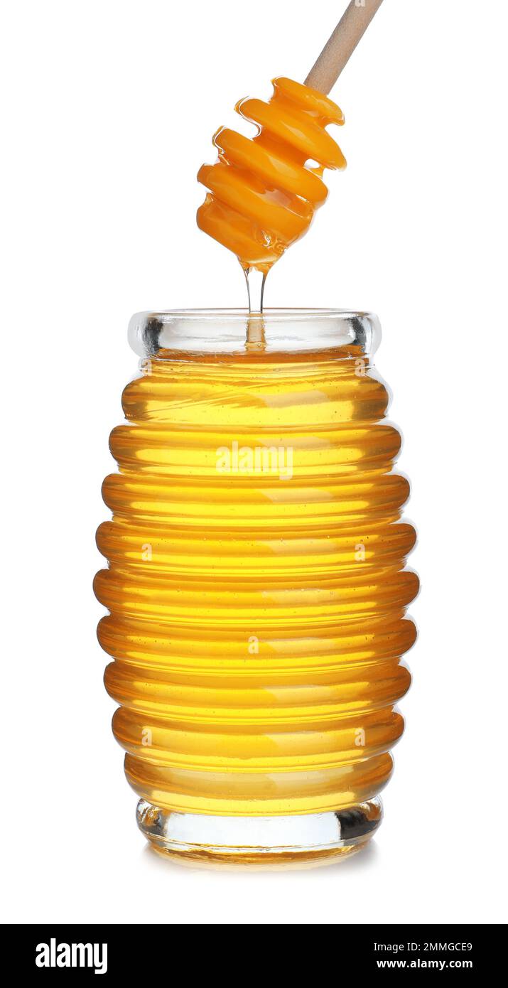 Honey dripping from dipper into jar isolated on white Stock Photo - Alamy