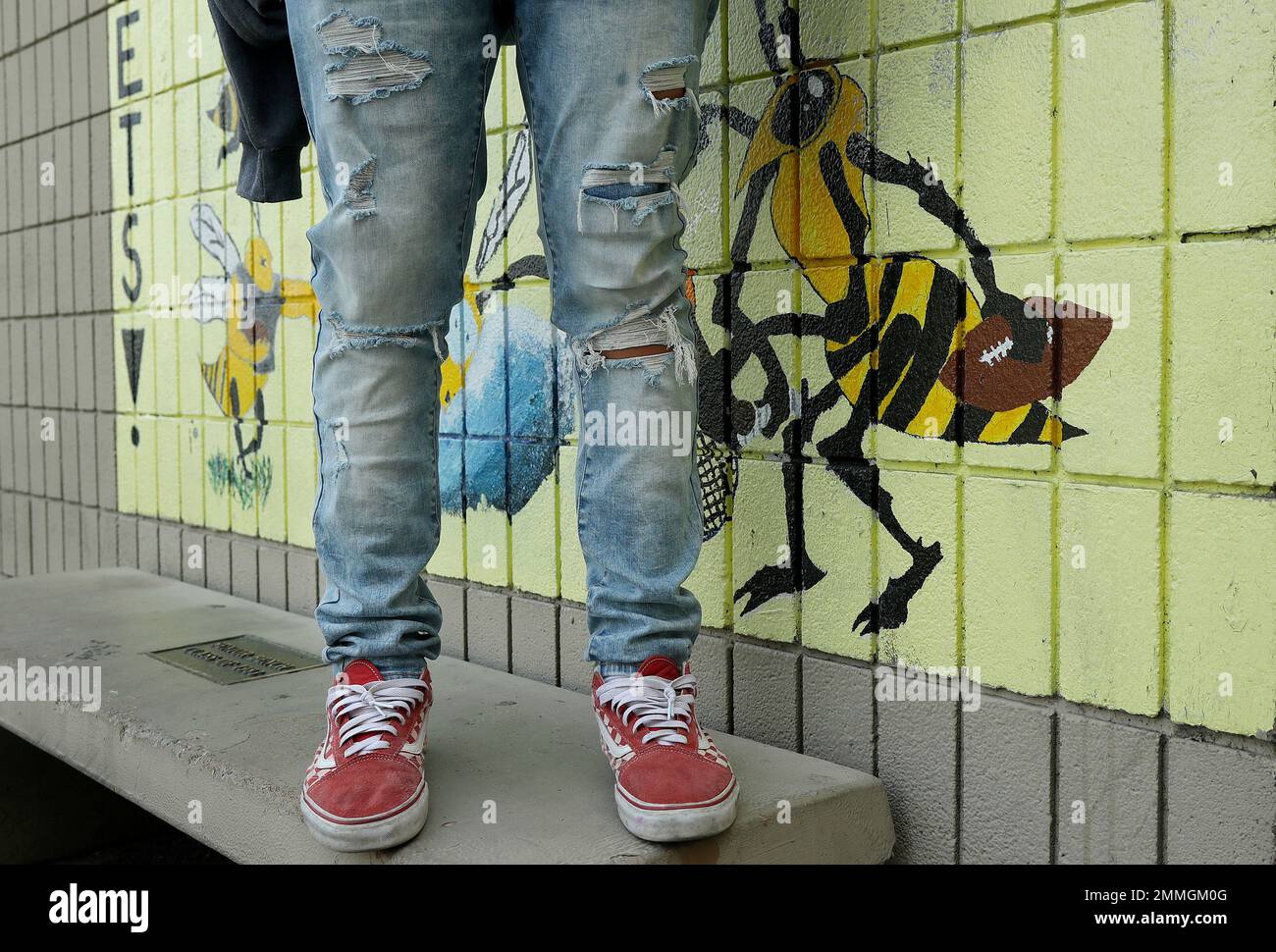 An Alameda High School student poses for photos wearing ripped jeans on