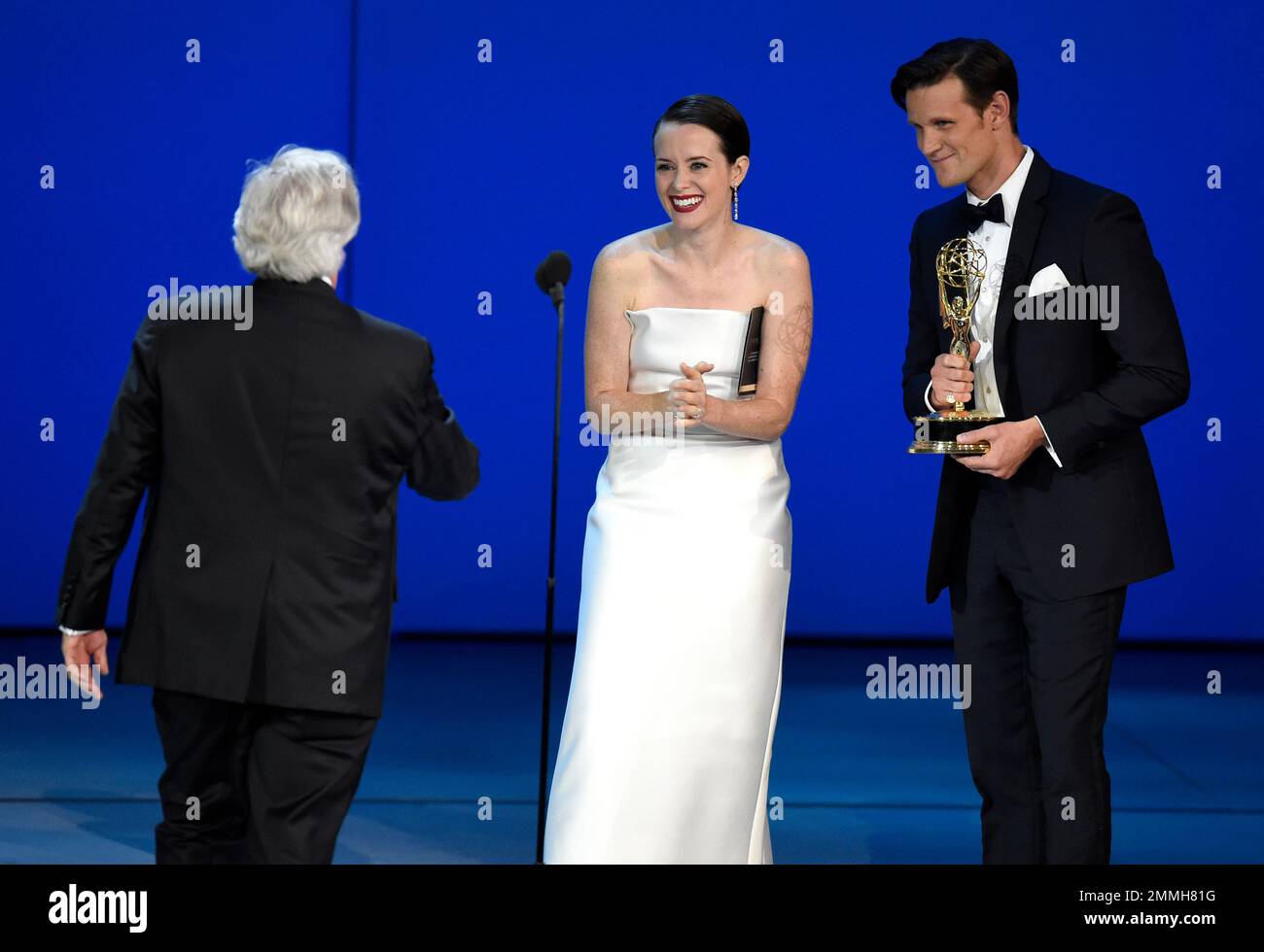 Henry Winkler, left, goes on stage to accept the award for outstanding