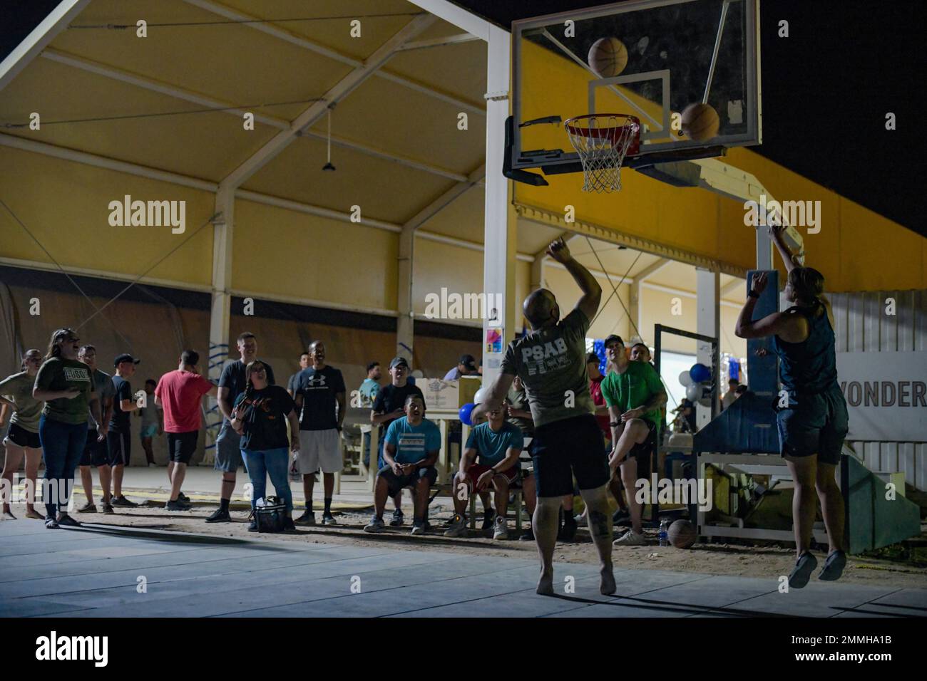 U.S. service members deployed to Prince Sultan Air Base, Kingdom of Saudi Arabia, play a game of knockout basketball during a U.S. Air Force 75th Anniversary party at PSAB, Sept.18, 2022. The USAF official separated from the U.S. Army with the signing of the National Security Act of 1947 by former U.S. President Harry Truman. Fly, Fight and Win - Airpower Anytime, Anywhere! Stock Photo