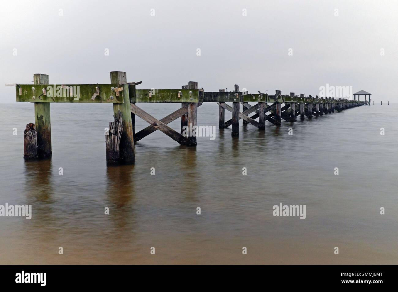 A washed out pier extending into the Gulf of Mexico in Biloxi, Mississippi, USA. Stock Photo