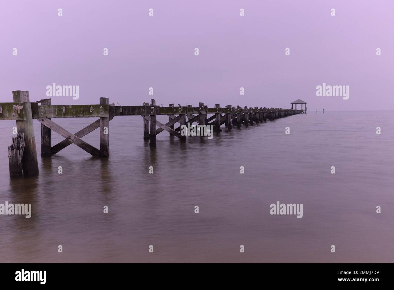 A washed out pier stretches into the Gulf of Mexico in Biloxi, Mississippi. Stock Photo